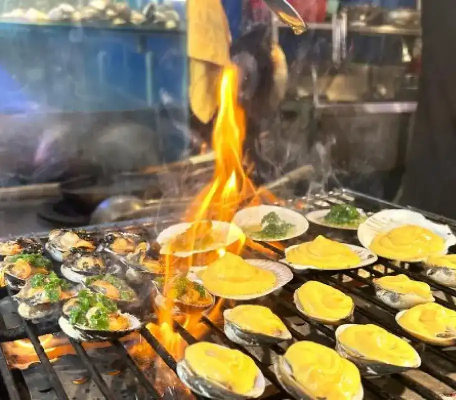 Local street food table in Vietnam with traditional dishes and Vietnamese coffee