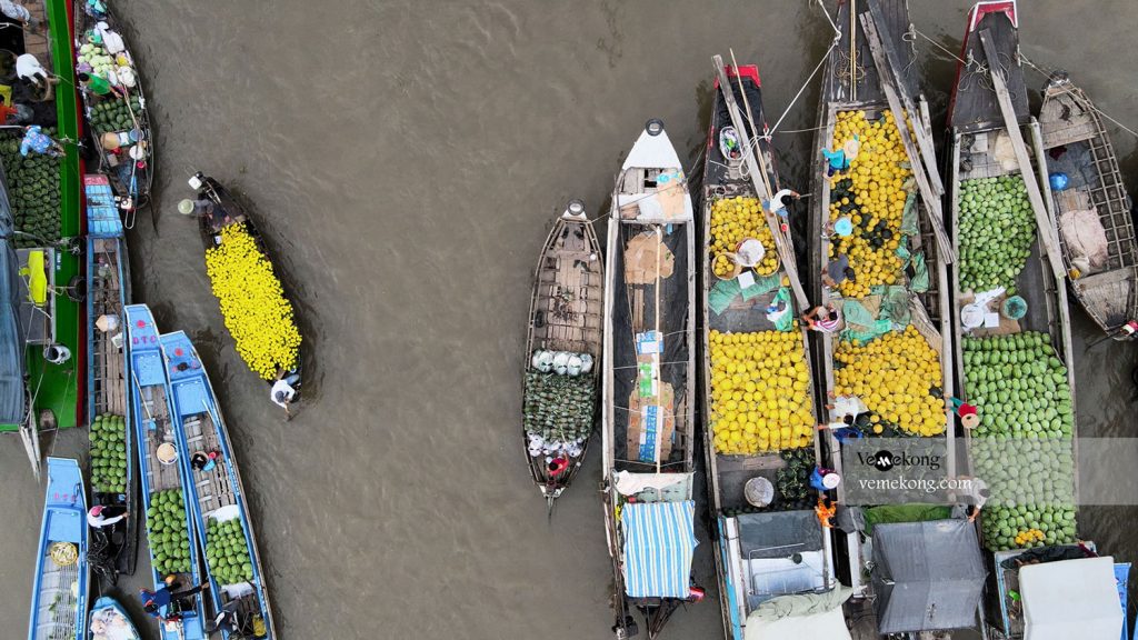 Cai Rang floating market — aerial view of boats laden with melons and produce on the Can Tho river