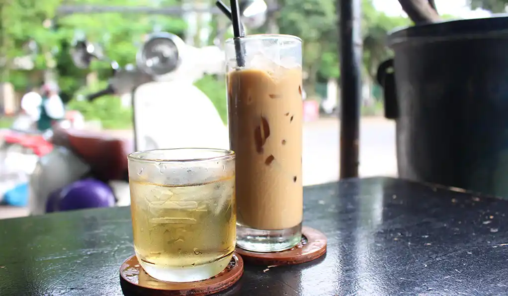 Saigon coffee scenes — iced coffee and tea on a roadside table