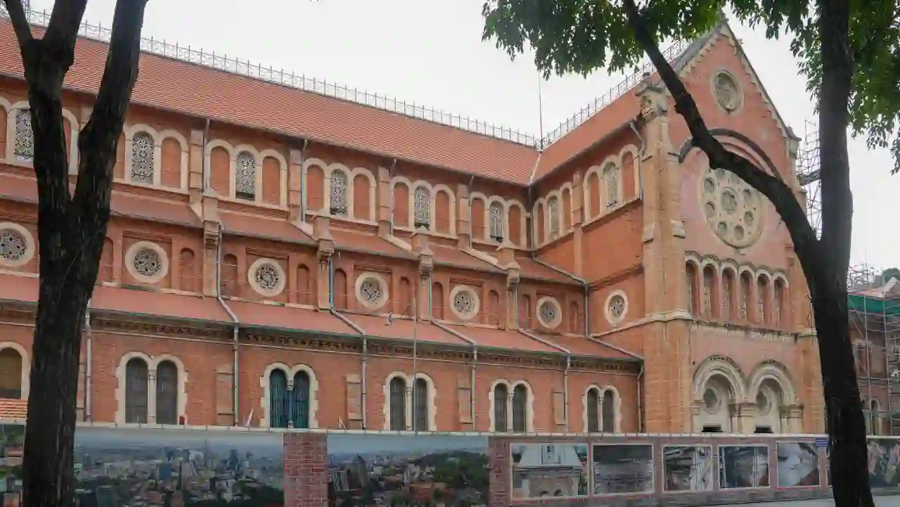Notre Dame Cathedral Basilica of Saigon red brick facade with rose window